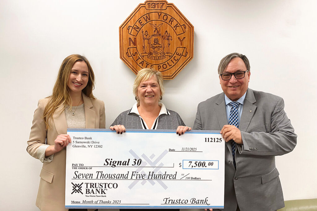 Check presentation from Trustco Bank to Signal 30 for $7,500 in celebration of Month of Thanks